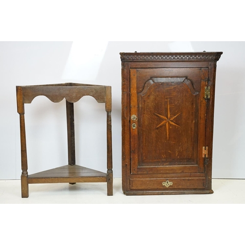 697 - Georgian oak corner cupboard, with dentil cornice above panelled door with parquetry geometric star ... 