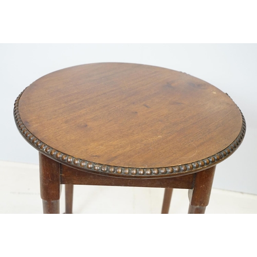 702 - Early 20th Century oak side table having a round top with reeded rim and turned legs. Measures 51 x ... 