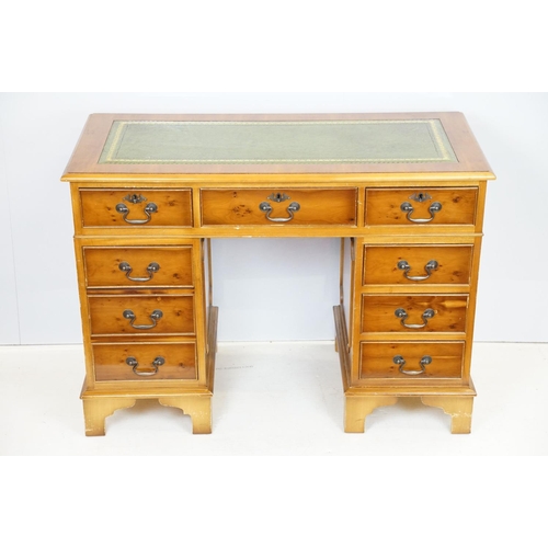 704 - 20th Century walnut veneered twin pedestal desk having a green leather top with three drawers to des... 