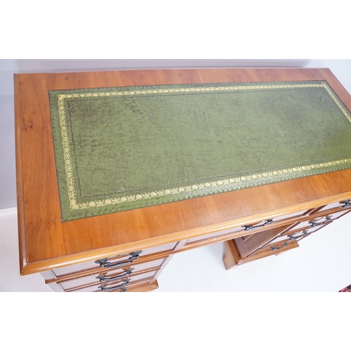 704 - 20th Century walnut veneered twin pedestal desk having a green leather top with three drawers to des... 