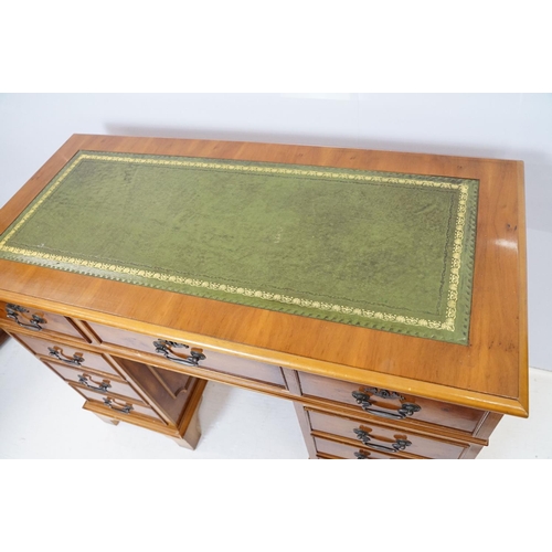 704 - 20th Century walnut veneered twin pedestal desk having a green leather top with three drawers to des... 