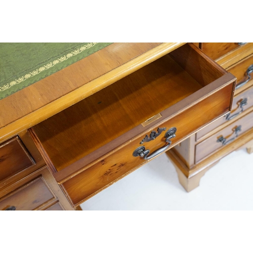 704 - 20th Century walnut veneered twin pedestal desk having a green leather top with three drawers to des... 