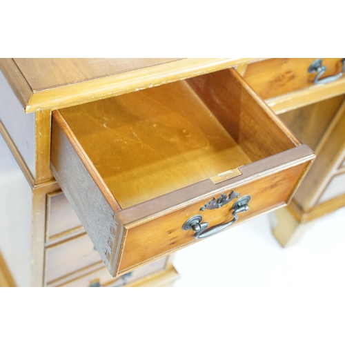 704 - 20th Century walnut veneered twin pedestal desk having a green leather top with three drawers to des... 