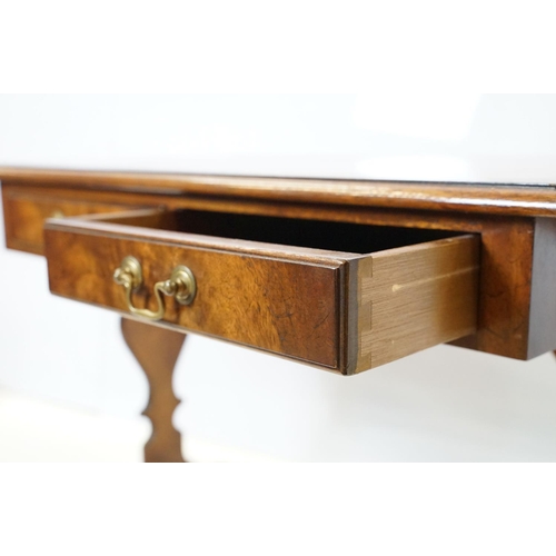 696 - 20th Century mahogany occasional coffee / side table having a shaped top with twin drawers beneath e... 