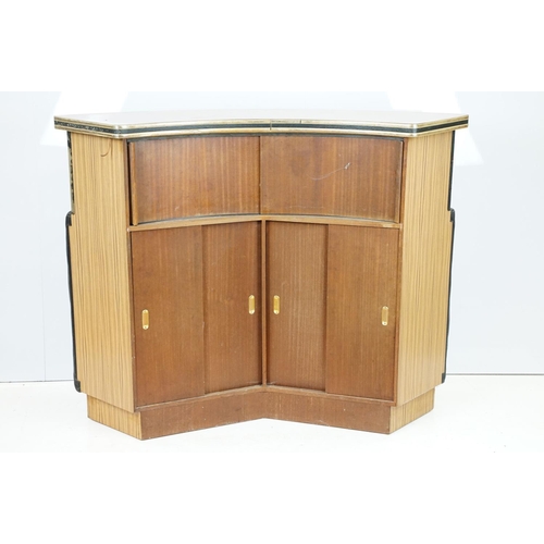 810 - Mid 20th century curved bar with glass windows above the buttoned cushioned front, with sliding door... 