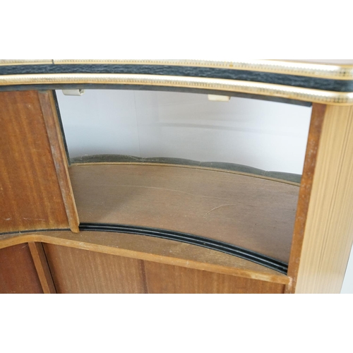 810 - Mid 20th century curved bar with glass windows above the buttoned cushioned front, with sliding door... 