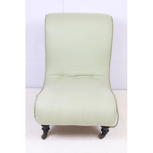 649 - Edwardian nursing chair, with scroll back, upholstered in green on turned tapering legs and castors,... 