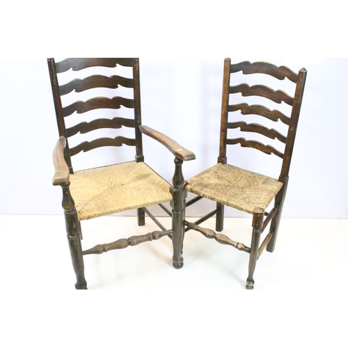 654 - Set of five oak ladder back chairs, including one chair with arms, all with rush seats