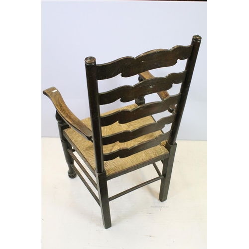 654 - Set of five oak ladder back chairs, including one chair with arms, all with rush seats