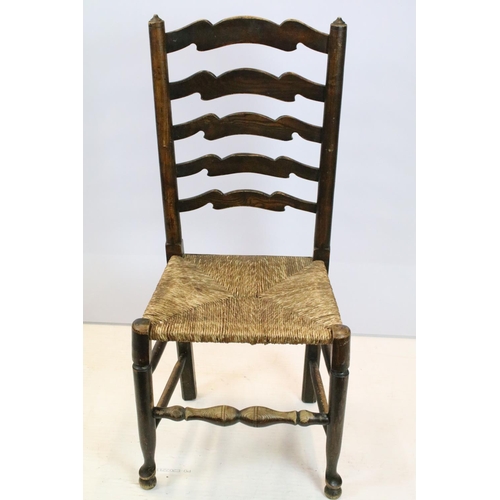 654 - Set of five oak ladder back chairs, including one chair with arms, all with rush seats