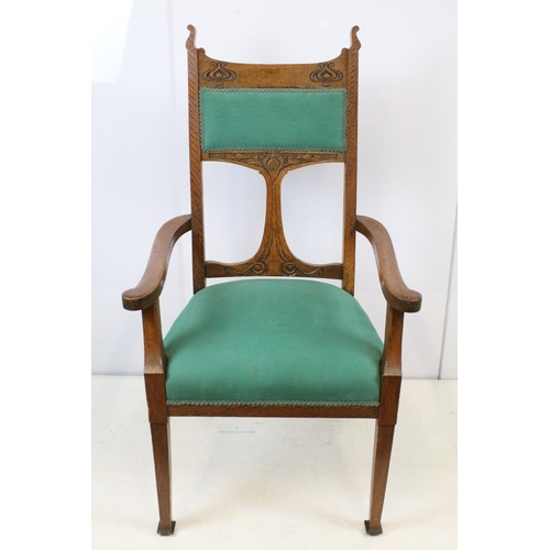 655 - Art Nouveau carved oak open armchair, with ornately carved back, upholstered in green, on tapering l... 