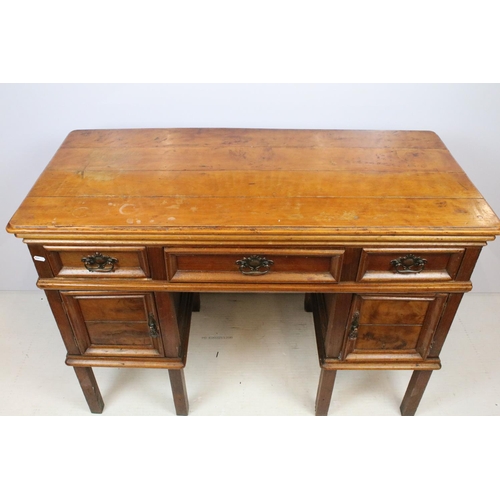 747 - Early 20th century kneehole desk with an arrangement of three drawers above two cupboard drawers wit... 