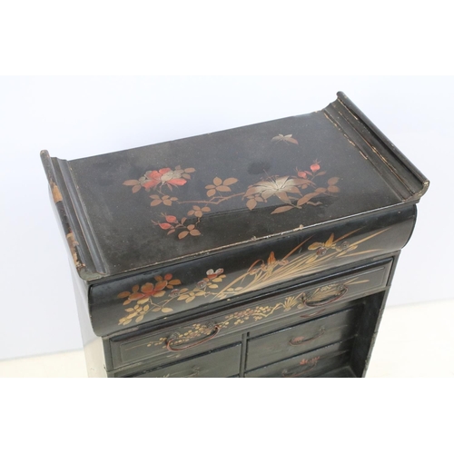 748 - Oriental lacquered cabinet, the japanned surface painted with flowers and branches, with an arrangem... 