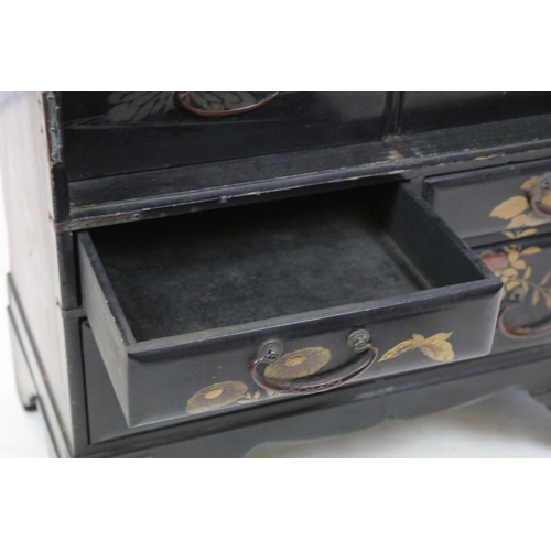 748 - Oriental lacquered cabinet, the japanned surface painted with flowers and branches, with an arrangem... 