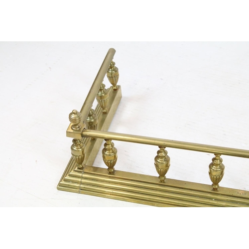 680 - Early 20th century brass fire fender, with fluted baluster shape galleried design, 18cm high x 106.5... 