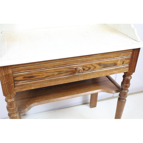 688 - 20th century pine washstand, the marble top with shelf above, with one drawer above turned legs and ... 