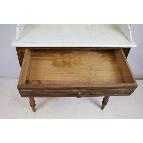 688 - 20th century pine washstand, the marble top with shelf above, with one drawer above turned legs and ... 