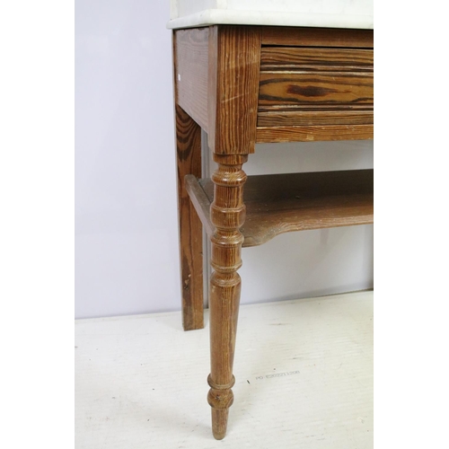 688 - 20th century pine washstand, the marble top with shelf above, with one drawer above turned legs and ... 