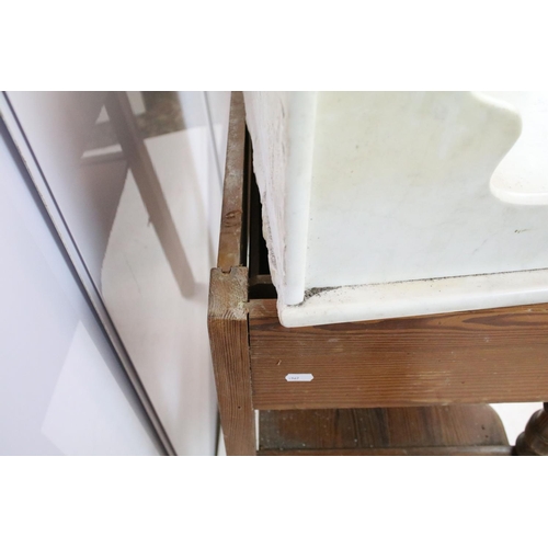 688 - 20th century pine washstand, the marble top with shelf above, with one drawer above turned legs and ... 