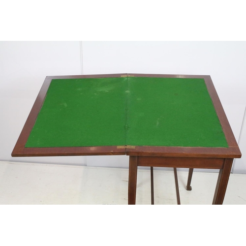 714 - Edwardian mahogany inlaid folding green baize lined card table, the top with oval panel, with stretc... 