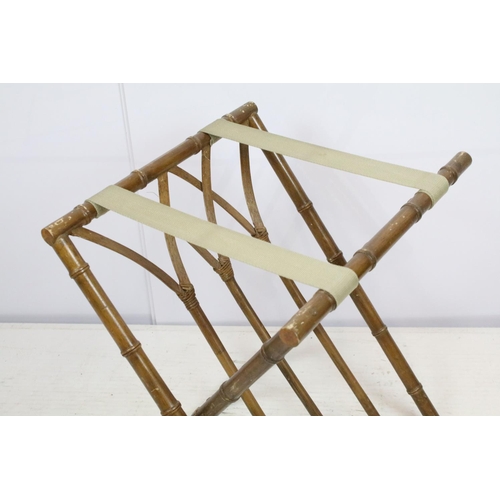 725 - Folding luggage stand, the wooden supports turned to resemble bamboo, with cane work, 57cm high x 41... 