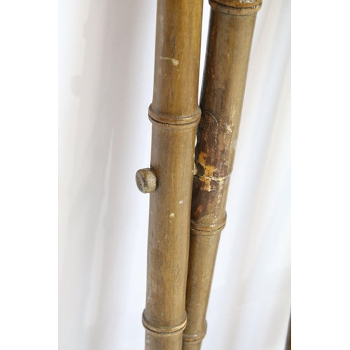 725 - Folding luggage stand, the wooden supports turned to resemble bamboo, with cane work, 57cm high x 41... 