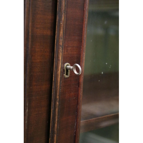 729 - Early 20th century mahogany breakfront bookcase, the upper section with dentil moulding above astrag... 