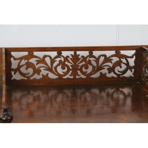 761 - Early 20th century rosewood carved three tier shelf, with raised fretwork galleried back above spira... 