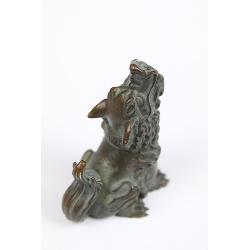 290 - A Chinese bronze ornamental seated foo dog.