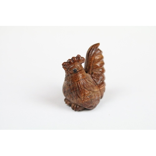 294 - Three Chinese carved wooden netsuke in the form of a Monkey, dog and cockerel.