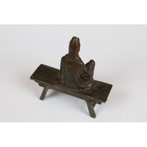 299 - A Chinese bronze of a seated Buddha, approx 8cm in height.