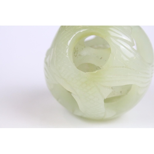 309 - Jade Puzzle Ball carved with a fish design comprising three layers plus a central ball, 6cm wide, on... 