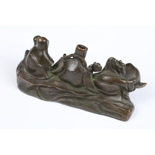 315 - An ornamental Chinese bronze of three Chinese Buddha's