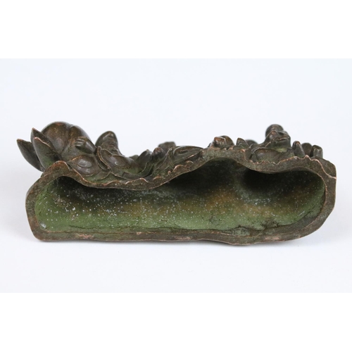 315 - An ornamental Chinese bronze of three Chinese Buddha's