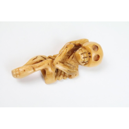 316 - Two carved Netsuke in the the form of skeletal figures.