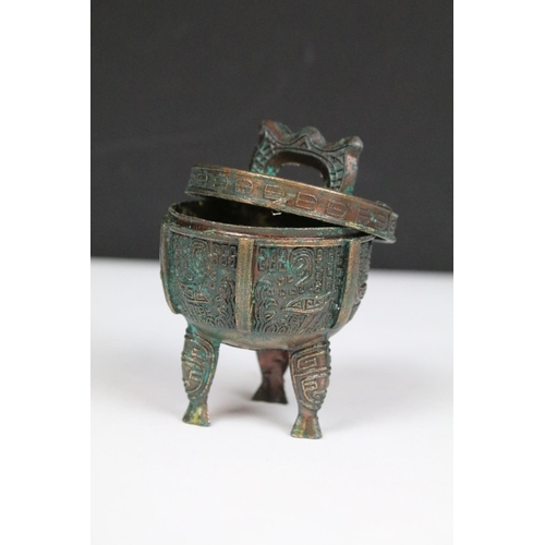 317 - A collection of three brass Chinese ornaments to include figures and a table bell together with an i... 