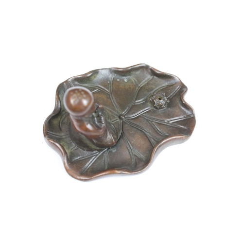 323 - A Chinese bronze burner in the form of a praying monk on leaf.