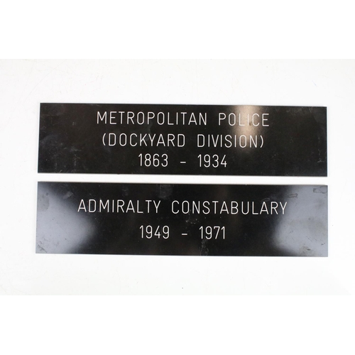 337 - A framed group of Royal New Zealand Police badges together with two police signs.