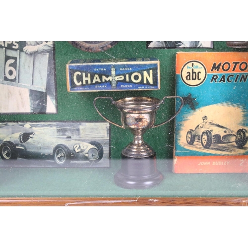 339 - A small group of Motor Racing collectables within a fitted display case.