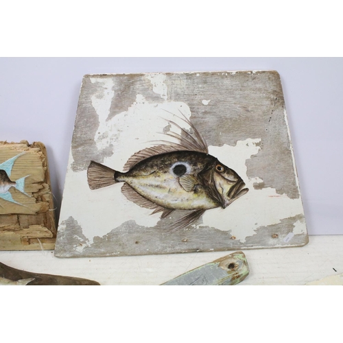 514 - Five oil paintings of fish on wood, to include a painting of a trout on driftwood (driftwood approx ... 