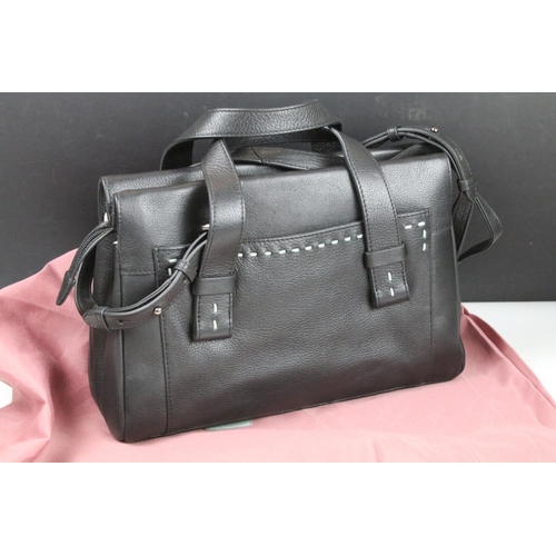 394 - Two Radley handbags to include a black leather handbag and a pink example, both housed within pink R... 