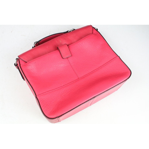 394 - Two Radley handbags to include a black leather handbag and a pink example, both housed within pink R... 