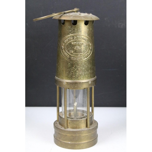 401 - Group of four brass miners lamps to include E. Thomas & Williams Ltd, Ferndale Mining Co., etc (tall... 