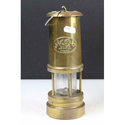 401 - Group of four brass miners lamps to include E. Thomas & Williams Ltd, Ferndale Mining Co., etc (tall... 