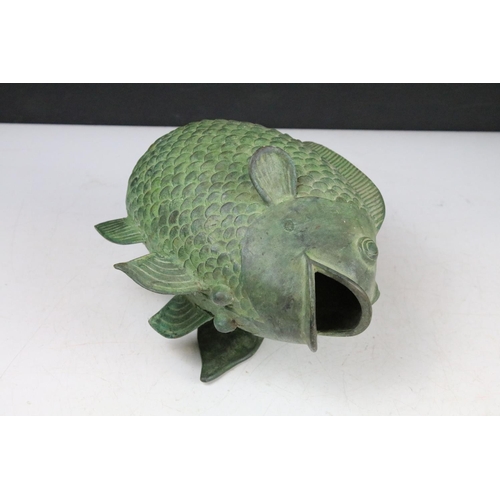 404 - Bronze model of a koi carp, together with a Hong Kong ceramic figure, carved soapstone ornament, and... 