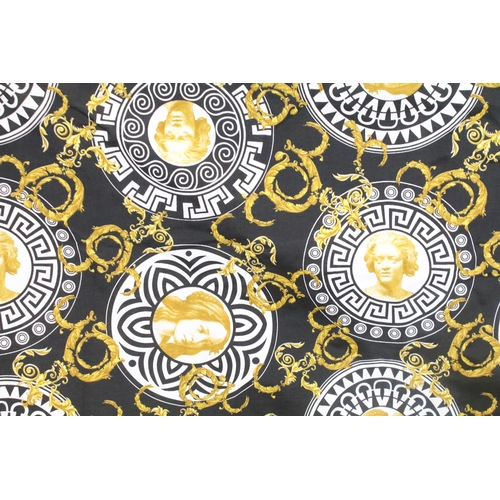 408 - Large piece of black ground Versace style fabric, with repeating spiralling gold acanthus leaves