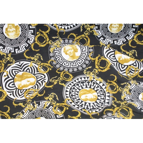 408 - Large piece of black ground Versace style fabric, with repeating spiralling gold acanthus leaves