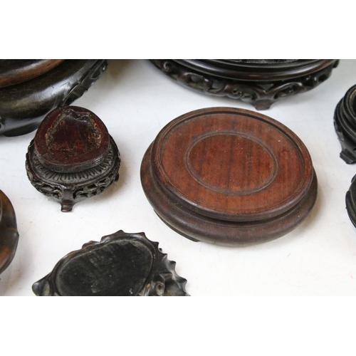 419 - Collection of Oriental hardwood stands to include pierced examples, largest approx 20cm diameter