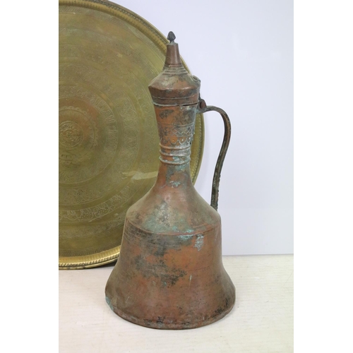 458 - Large antique Eastern copper jug, together with a large brass charger with bands of repeating decora... 