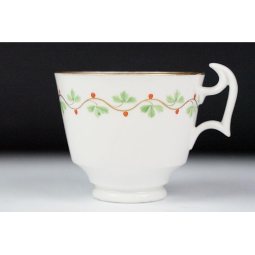 29 - Swansea pottery cup and saucer, hand painted with a floral garland, the saucer, 13.5cm diameter